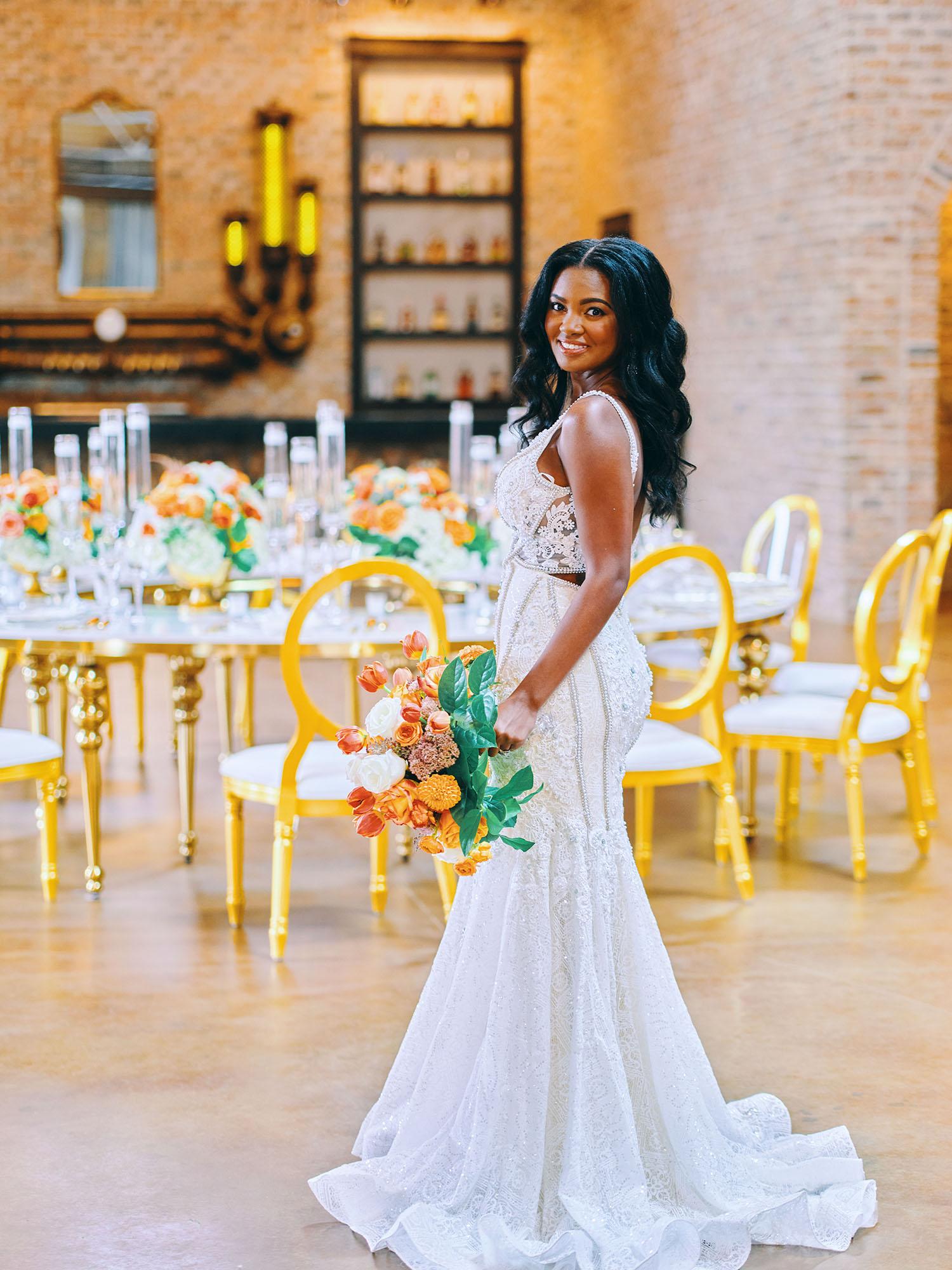 luxurious indoor wedding reception decor - gold luxury chairs - round table