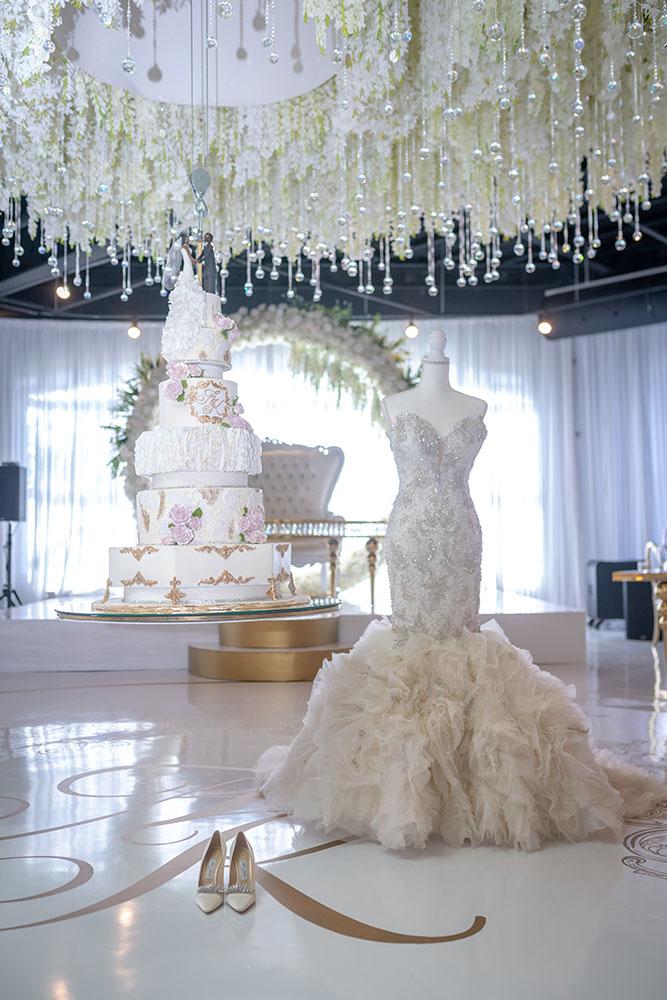 ceiling decor, cake drop, royal luxury, wedding reception decor, gold chairs, mirror tables, chargers, tableware, circle arch