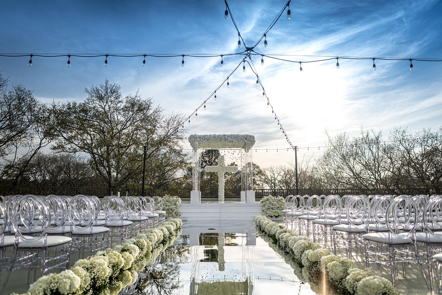 mirror aisle, royal luxury events, ceremony decor, ivory flowers, canopy, cross, clear chairs
