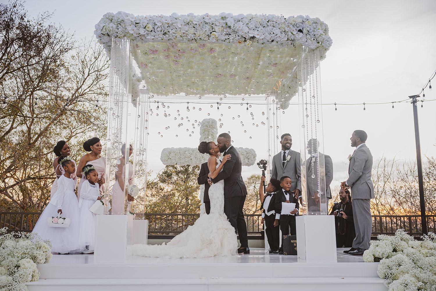 mirror aisle, royal luxury events, ceremony decor, ivory flowers, canopy, cross, clear chairs