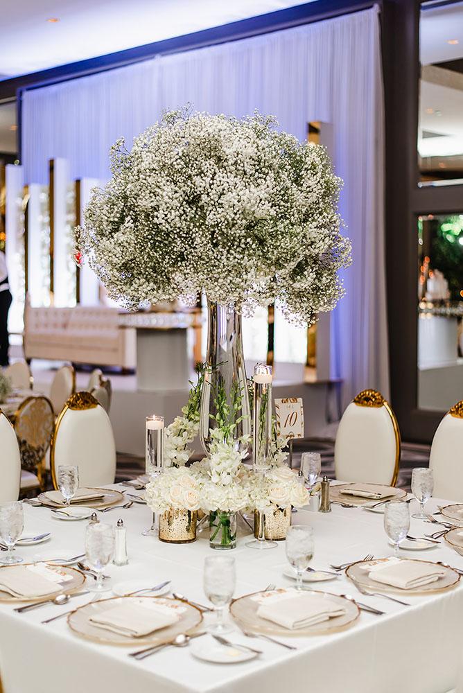 Wisteria, Baby's Breath, reception decor, omni houston, wedding decor, florist in houston, gold round table, mirror seating chart, wedding cake