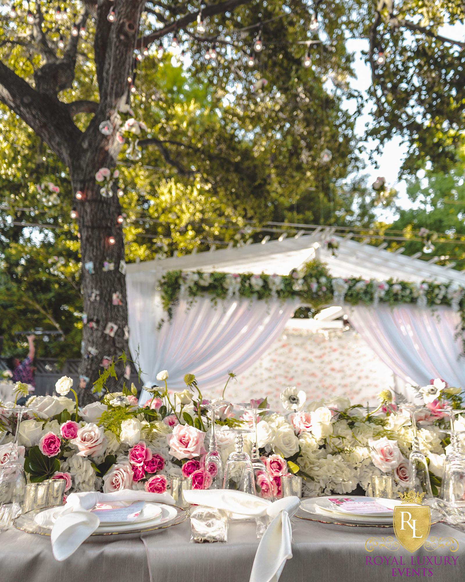 intimate backyard wedding decor featured pastel florals, white chairs, a greenery wall, and many other unique details - houston wedding decor