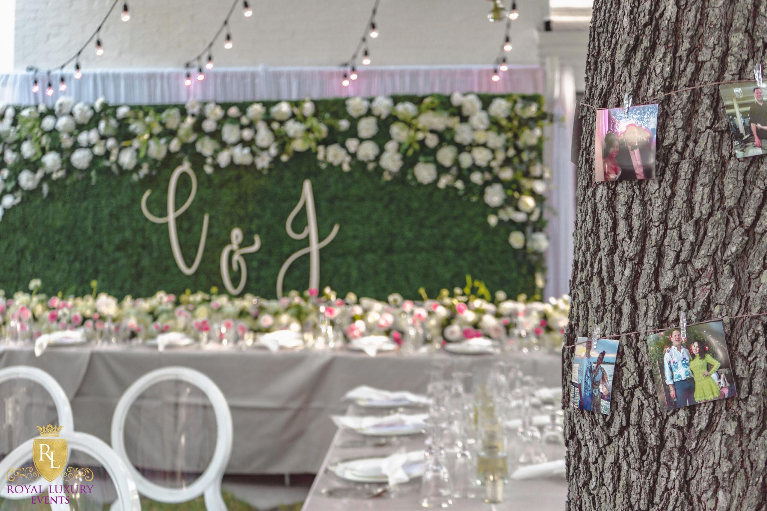 intimate backyard wedding decor featured pastel florals, white chairs, a greenery wall, and many other unique details - houston wedding decor