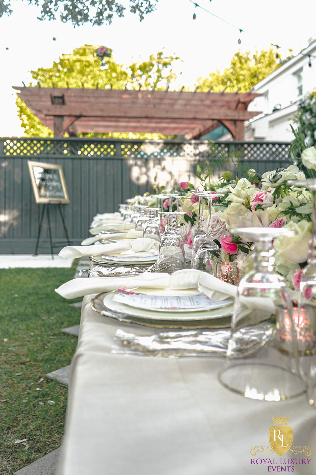 intimate backyard wedding decor featured pastel florals, white chairs, a greenery wall, and many other unique details - houston wedding decor