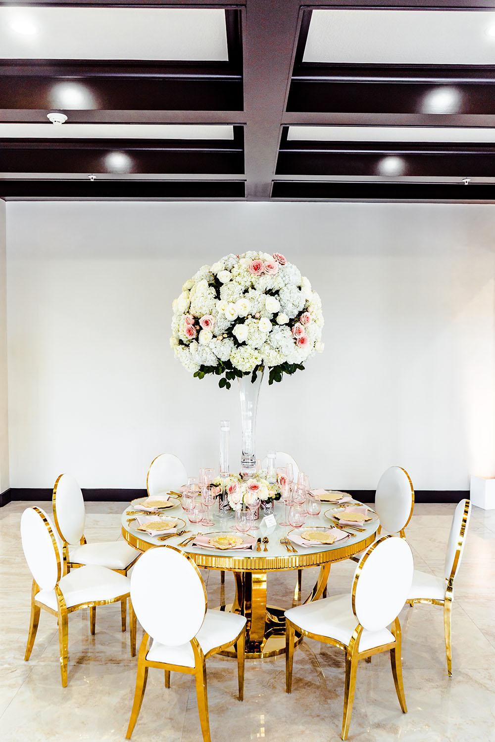 round table with tall floral centerpiece - palm royal villa - royal luxury events