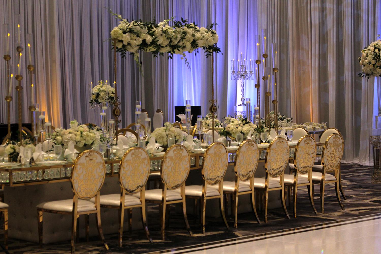 View this luxurious engagement party decor at The Post Oak Hotel at Uptown Houston. Featuring gold chairs, charger plates, & sweetheart table.