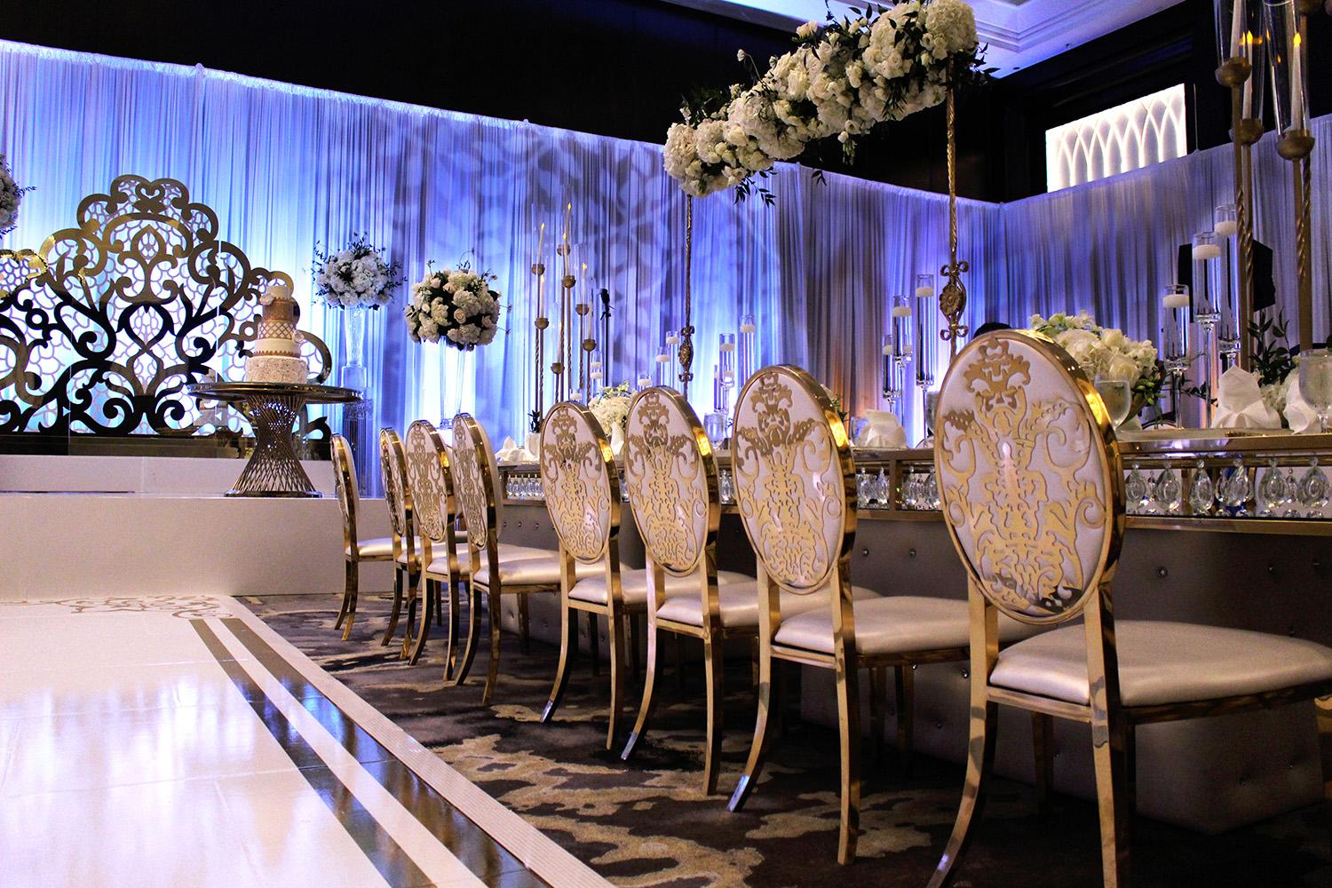 View this luxurious engagement party decor at The Post Oak Hotel at Uptown Houston. Featuring gold chairs, charger plates, & sweetheart table.