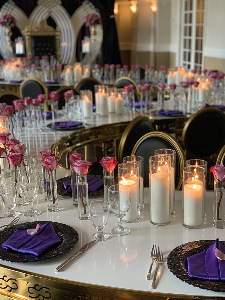 rehearsal dinner - black chairs - purple napkins - pink flowers - backdrop - bougainvilleas - serpentine tables - black charger plates