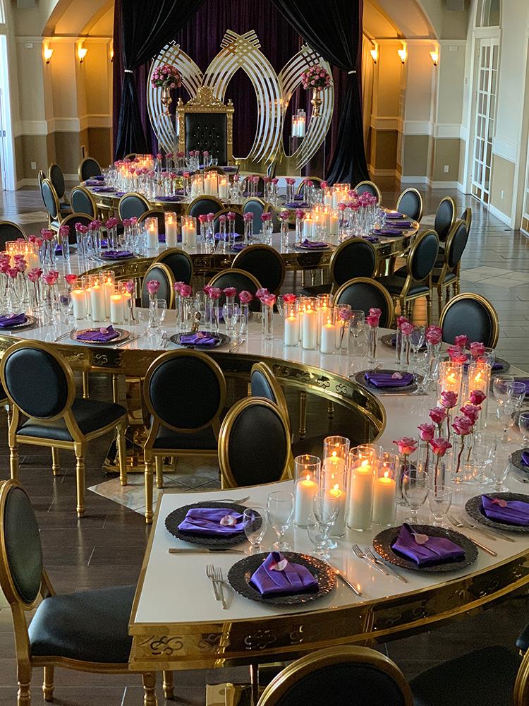 rehearsal dinner - black chairs - purple napkins - pink flowers - backdrop - bougainvilleas - serpentine tables - black charger plates