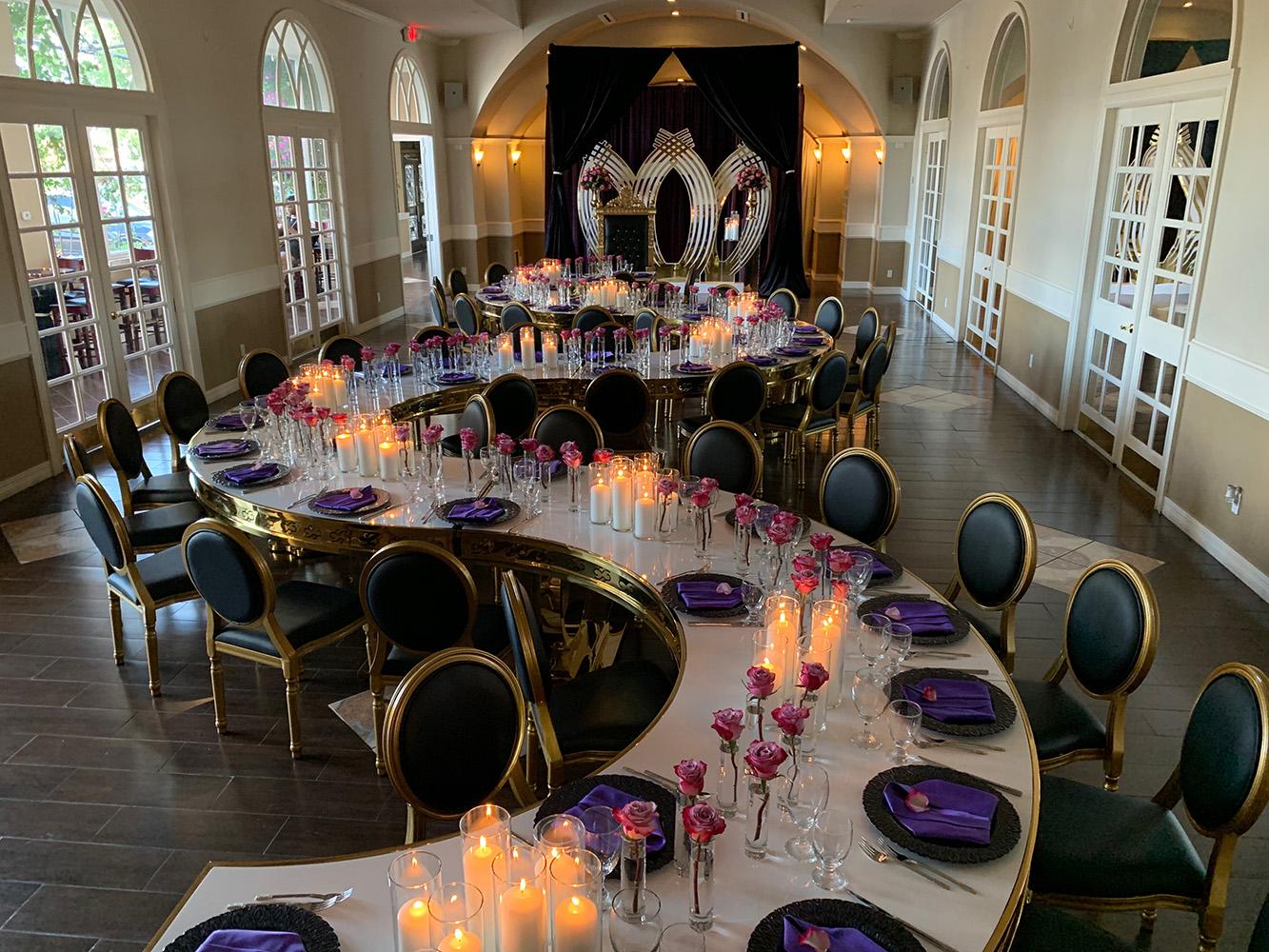 rehearsal dinner - black chairs - purple napkins - pink flowers - backdrop - bougainvilleas - serpentine tables - black charger plates