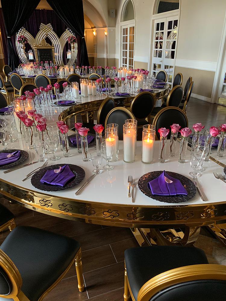 rehearsal dinner - black chairs - purple napkins - pink flowers - backdrop - bougainvilleas - serpentine tables - black charger plates