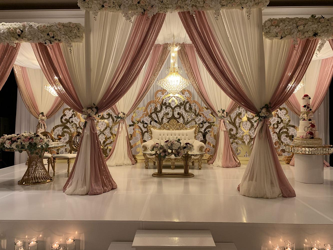 View Michelle and Anzon's luxury wedding at Houston Marriott Sugar Land, featuring pink white and red flowers with gold accented decor.