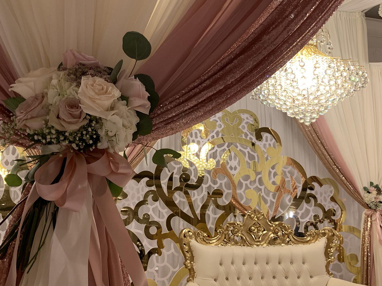 View Michelle and Anzon's luxury wedding at Houston Marriott Sugar Land, featuring pink white and red flowers with gold accented decor.