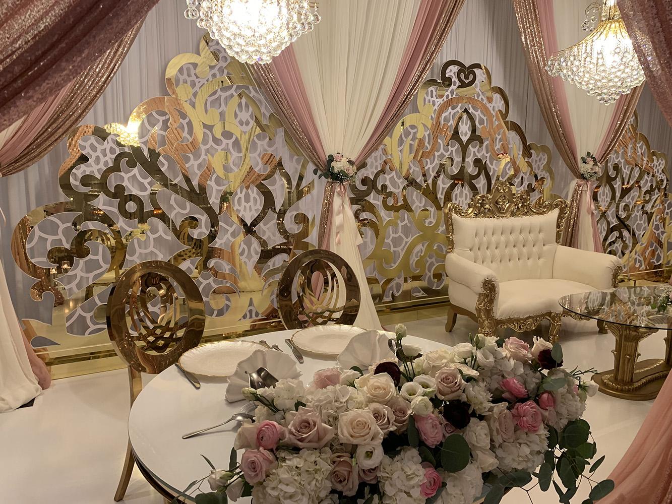 View Michelle and Anzon's luxury wedding at Houston Marriott Sugar Land, featuring pink white and red flowers with gold accented decor.