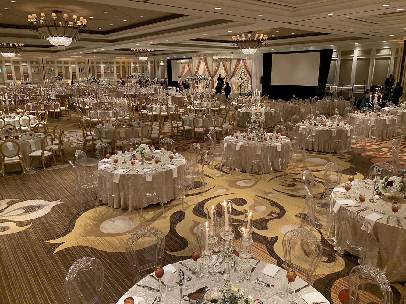 View Michelle and Anzon's luxury wedding at Houston Marriott Sugar Land, featuring pink white and red flowers with gold accented decor.