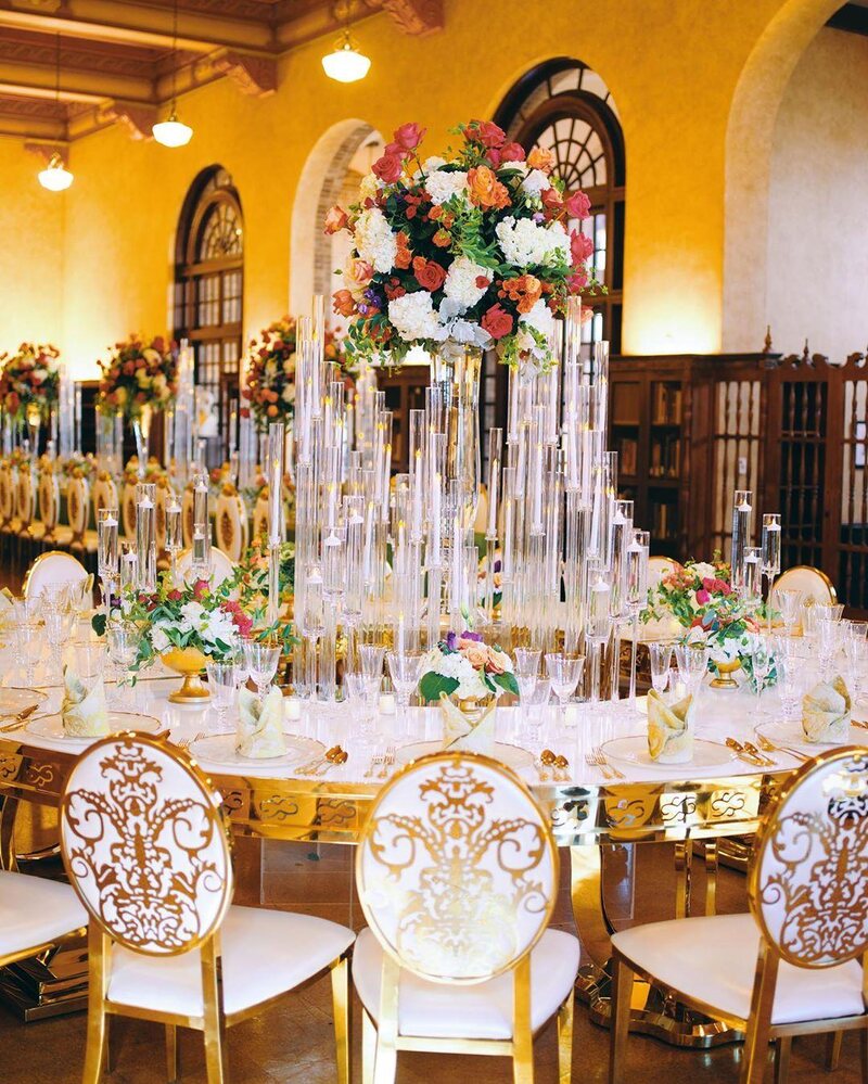 luxury wedding decor for weddings in houston at julia ideson library - gold chairs - long tables - clear vases