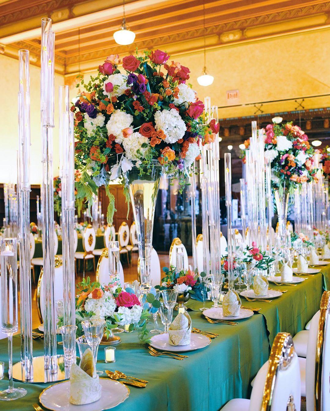 luxury wedding decor for weddings in houston at julia ideson library - gold chairs - long tables - clear vases