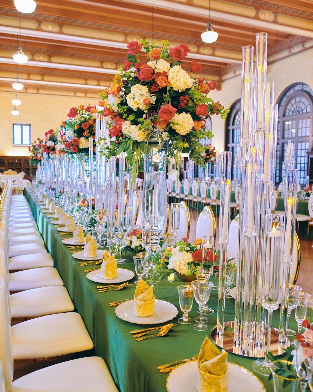 luxury wedding decor for weddings in houston at julia ideson library - gold chairs - long tables - clear vases