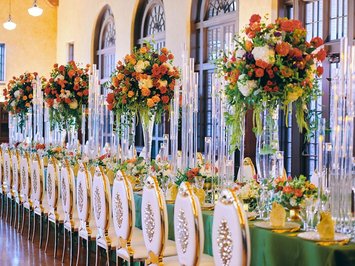 luxury wedding decor for weddings in houston at julia ideson library - gold chairs - long tables - clear vases