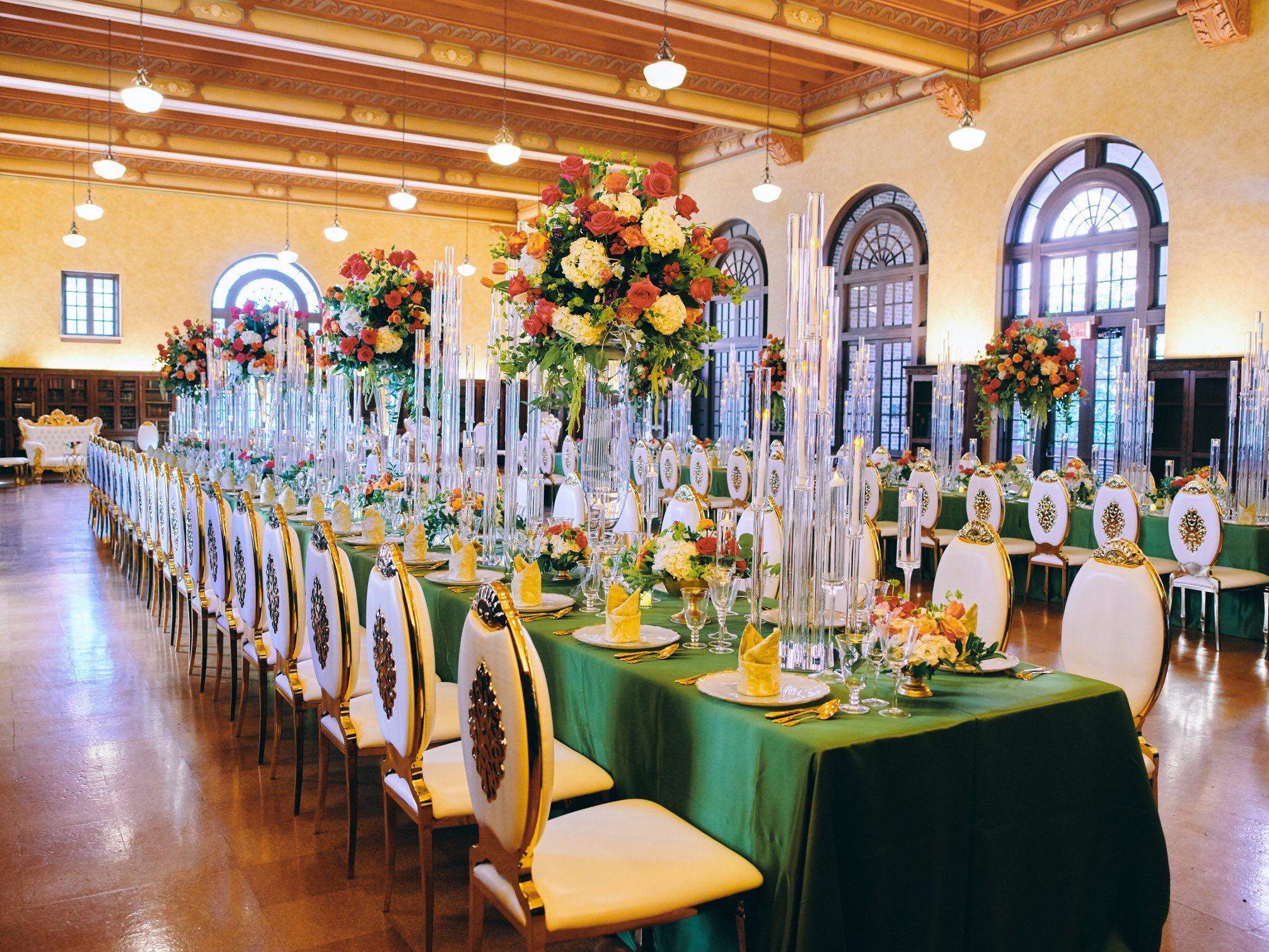 luxury wedding decor for weddings in houston at julia ideson library - gold chairs - long tables - clear vases