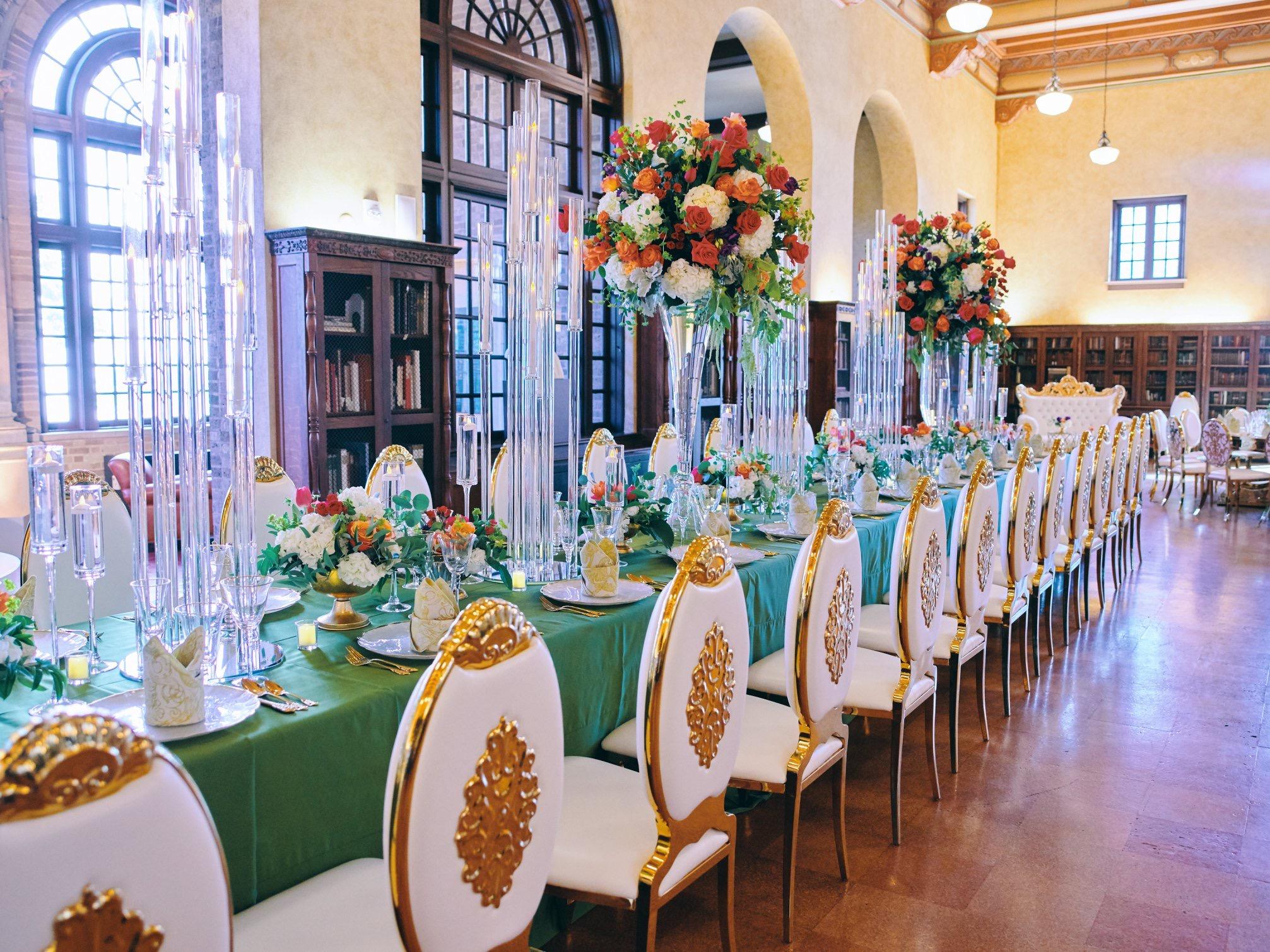 luxury wedding decor for weddings in houston at julia ideson library - gold chairs - long tables - clear vases