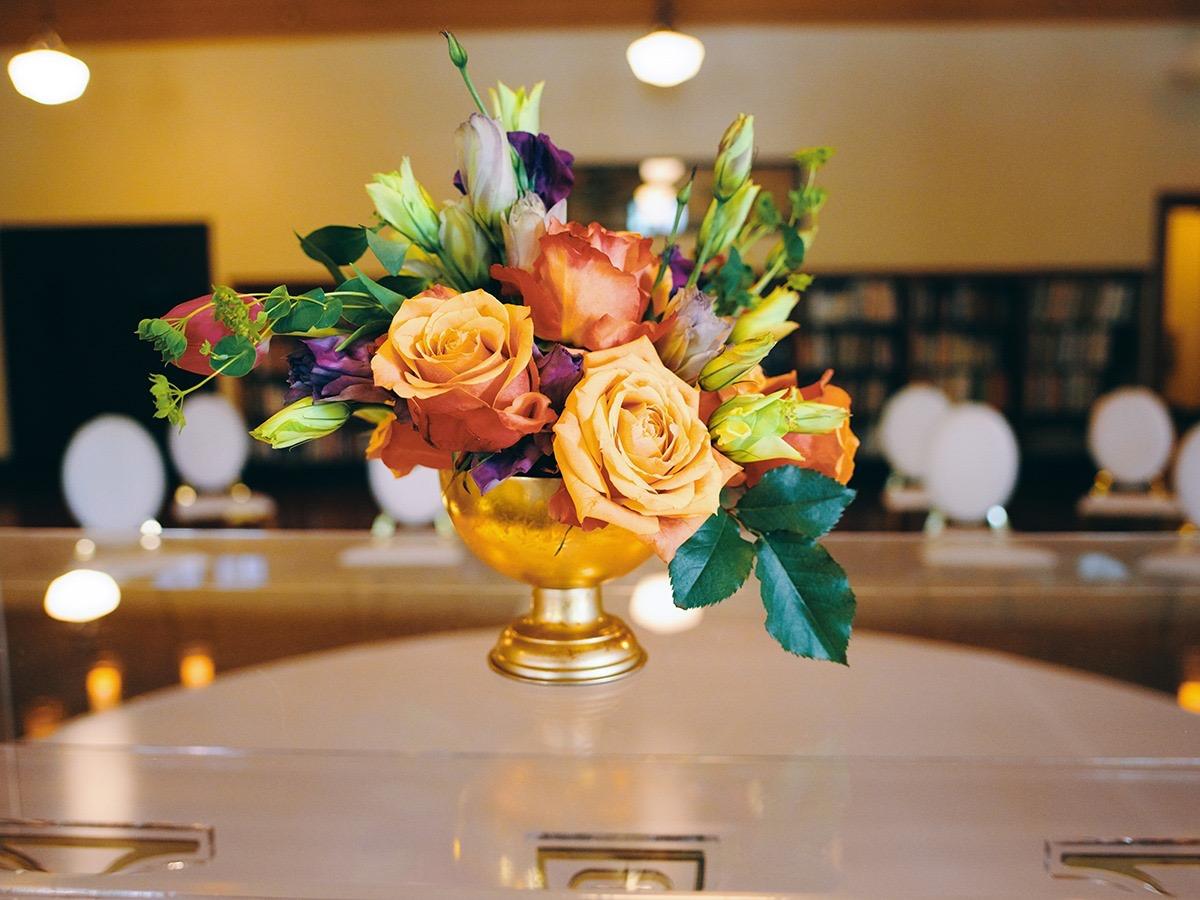 luxury wedding decor for weddings in houston at julia ideson library - gold chairs - long tables - clear vases