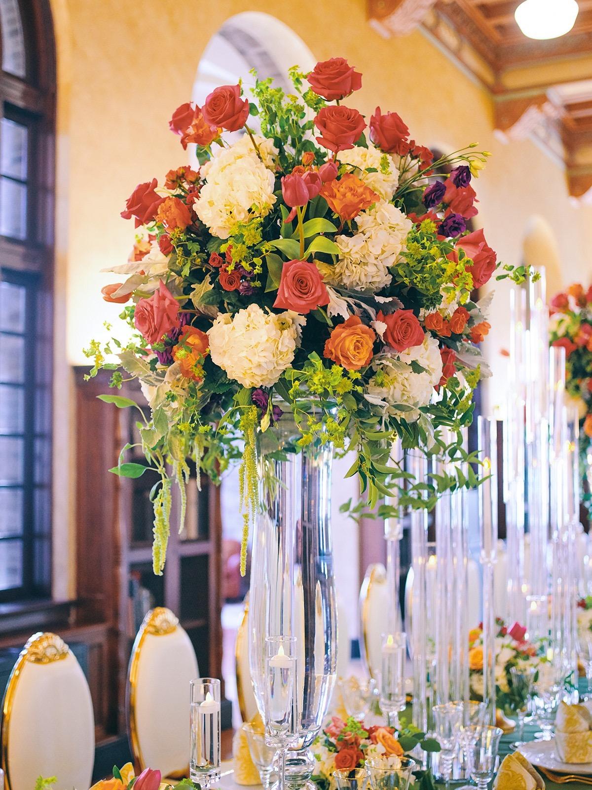 luxury wedding decor for weddings in houston at julia ideson library - gold chairs - long tables - clear vases