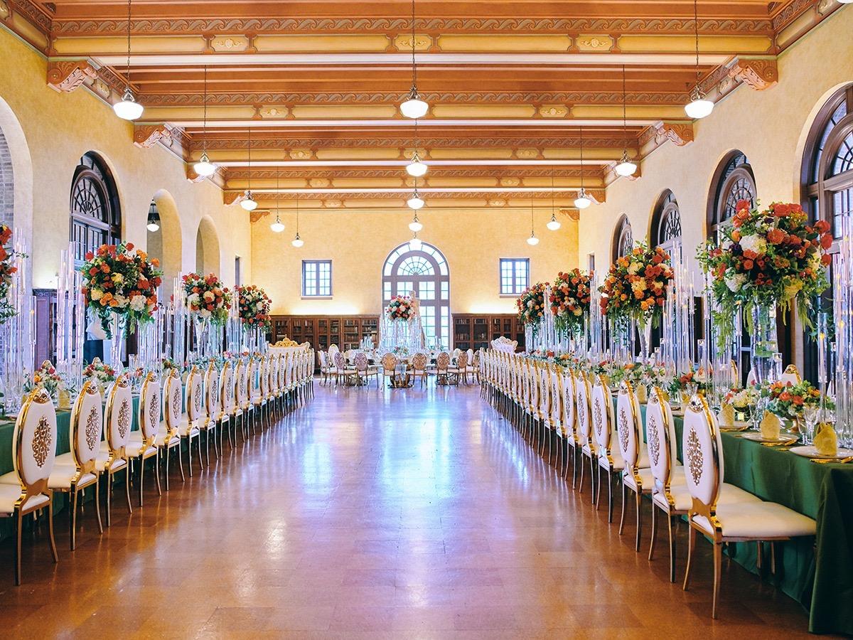 luxury wedding decor for weddings in houston at julia ideson library - gold chairs - long tables - clear vases
