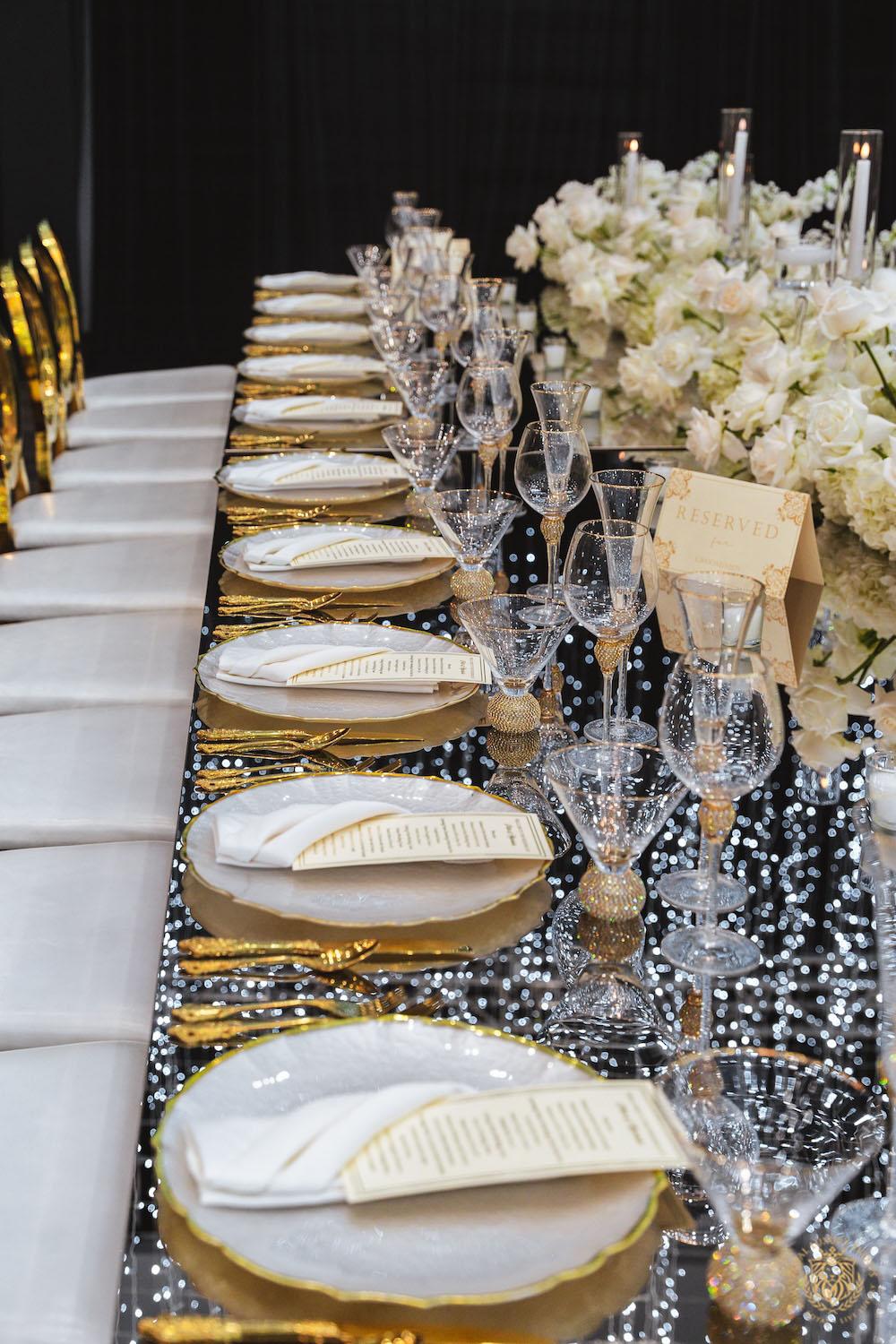 mirrored table top rental, gold and white chargers, wedding tablescape, luxury wedding place setting