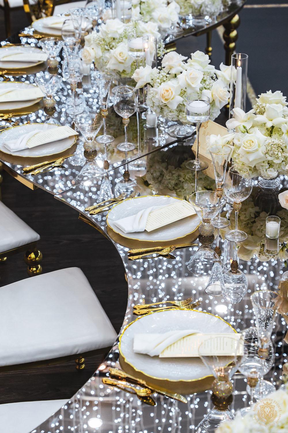 mirrored table top rental, gold and white chargers, wedding tablescape, luxury wedding place setting