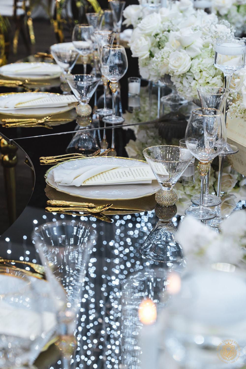 mirrored table top rental, gold and white chargers, wedding tablescape, luxury wedding place setting