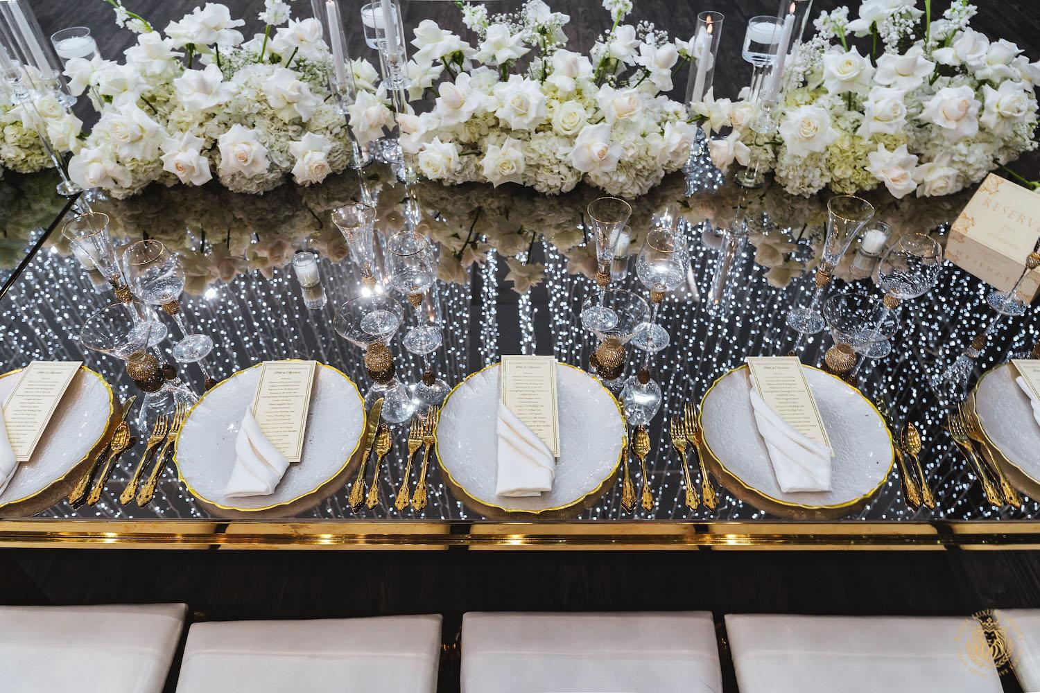 mirrored table top rental, gold and white chargers, wedding tablescape, luxury wedding place setting
