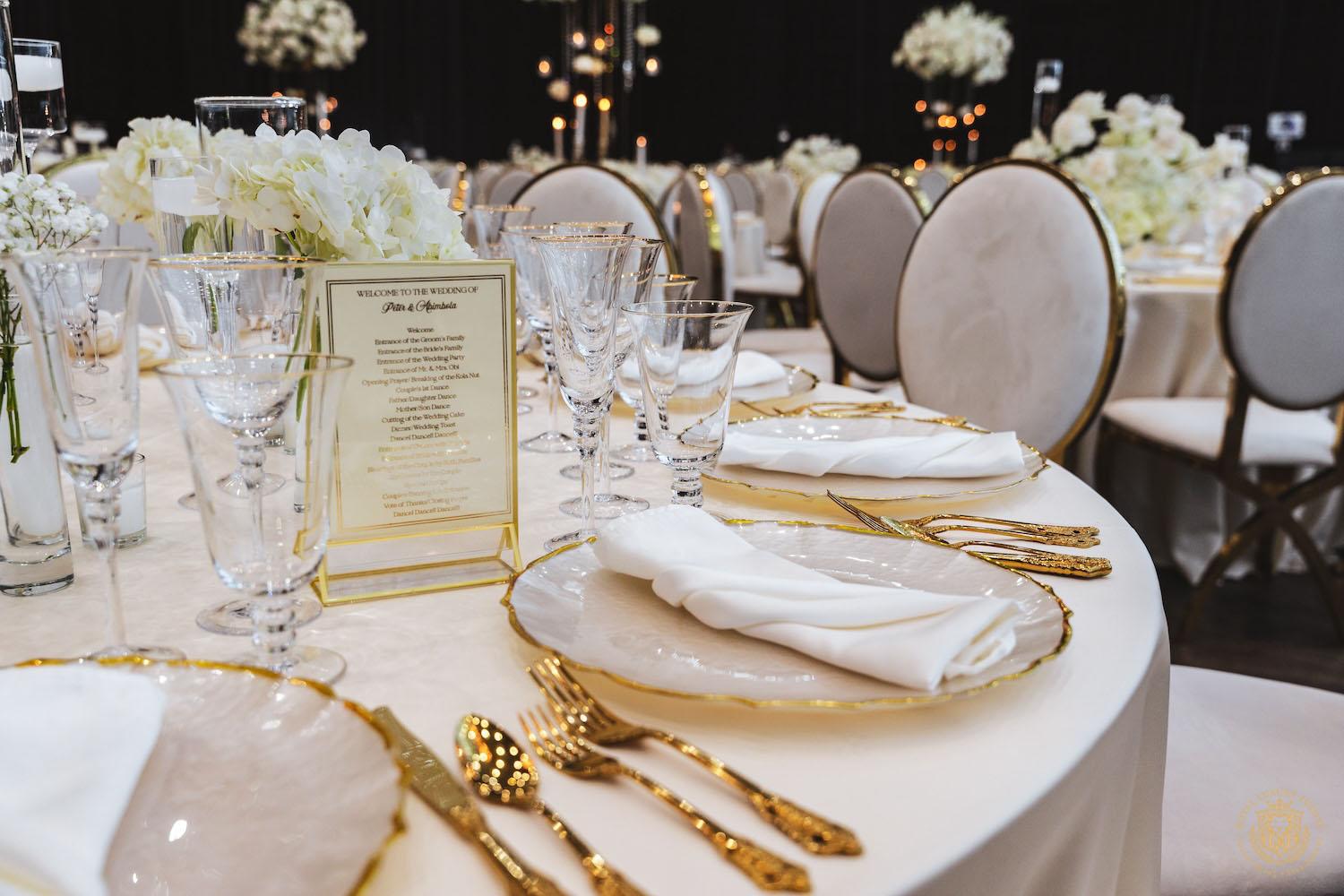 mirrored table top rental, gold and white chargers, wedding tablescape, luxury wedding place setting