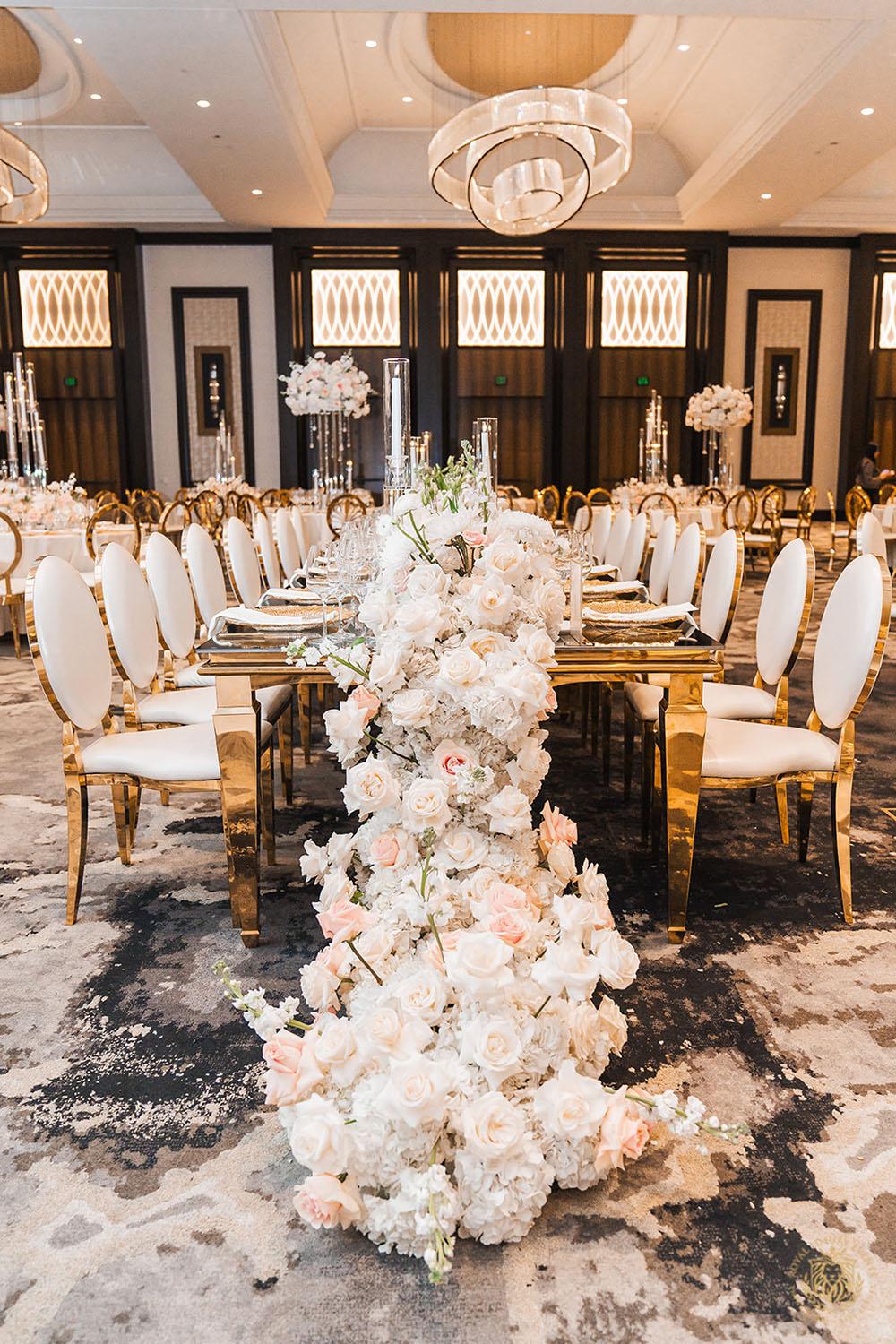 gold rectangle table, floral runner, wedding floral centerpieces, gold and white chair rentals, luxury wedding, wedding decor, wedding reception