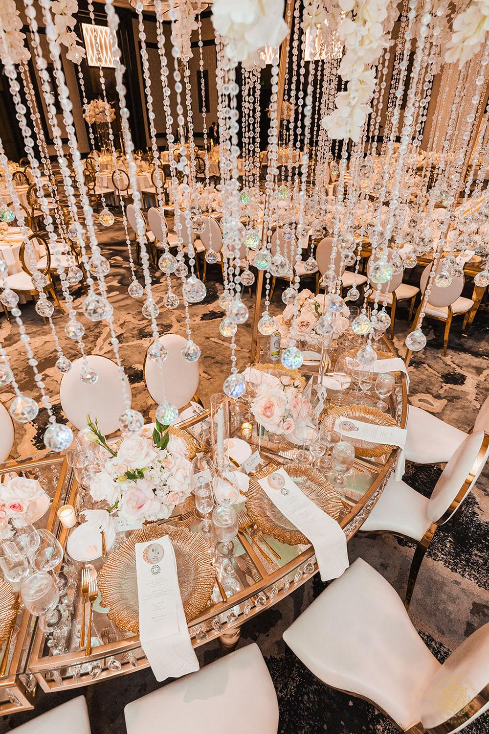 serpentine crystal table, unique wedding centerpieces, wedding reception decor, wedding chairs, white and gold chair rentals, tablescape, wedding place setting