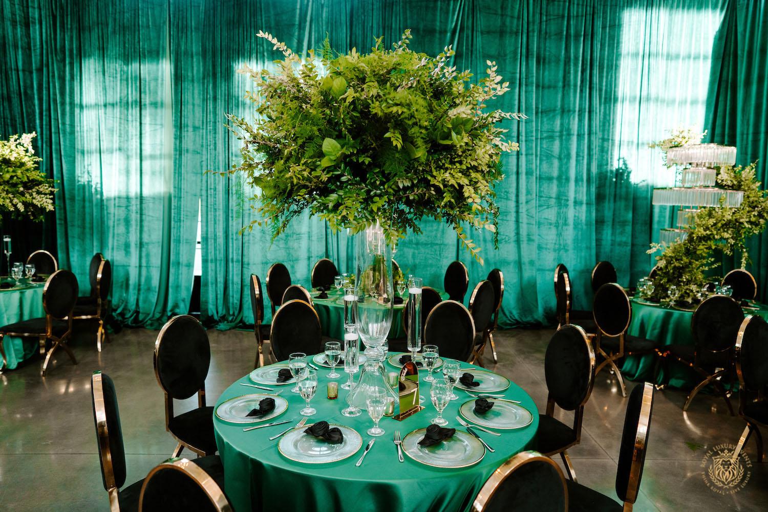 quinceañera decor, quinceañera theme, quinceañera ideas, luxury events, event designer, emerald, black, gold, greenery, florist, floral design, tall centerpieces, black and gold chairs, luxury chair rentals