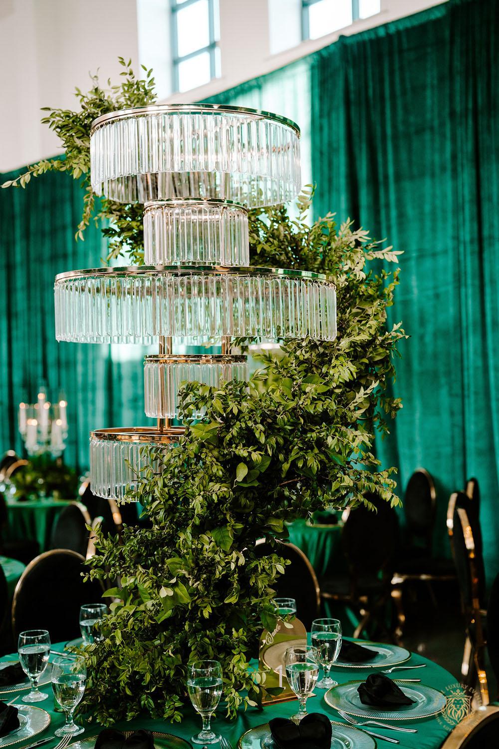 quinceañera decor, quinceañera theme, quinceañera ideas, luxury events, event designer, emerald, black, gold, greenery, florist, floral design, tall centerpieces, black and gold chairs, luxury chair rentals