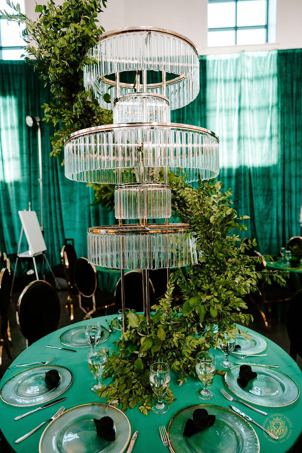 quinceañera decor, quinceañera theme, quinceañera ideas, luxury events, event designer, emerald, black, gold, greenery, florist, floral design, tall centerpieces, black and gold chairs, luxury chair rentals, chargers