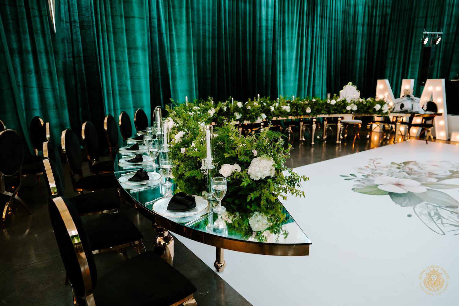 quinceañera decor, quinceañera theme, quinceañera ideas, luxury events, event designer, emerald, black, gold, greenery, florist, floral design, tall centerpieces, black and gold chairs, luxury chair rentals, curved table, luxury rentals, table rentals